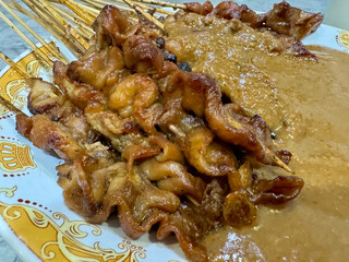 One plate of chicken satay with peanut sauce