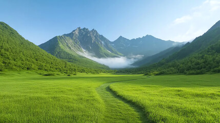 Obraz premium A breathtaking view of lush green valleys surrounded by majestic mountains under a clear blue sky, showcasing nature's beauty.