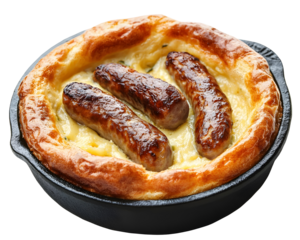 Traditional toad in the hole with sausages baked in Yorkshire pudding batter served in cast iron skillet isolated on transparent background