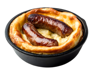 Traditional toad in the hole with sausages baked in Yorkshire pudding batter served in cast iron skillet isolated on transparent background