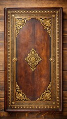 Antique leather book cover with gold accents and ornate patterns on a wooden table background