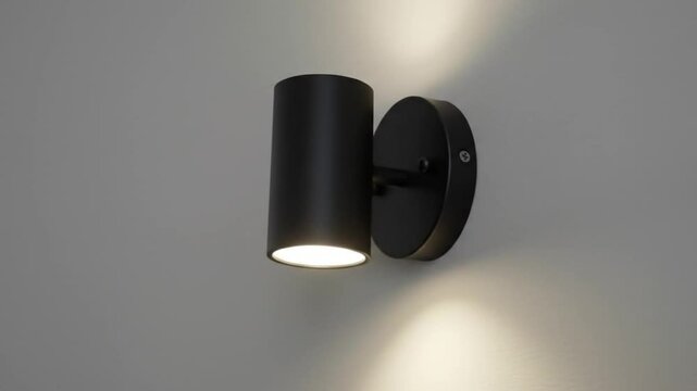 Minimalist black lamp illuminates gray wall