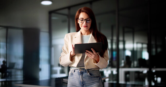 Busy Businesswoman Conducting Financial Analysis On Tablet - Powered by Adobe