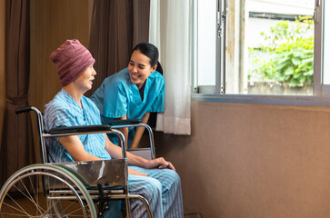 Cancer man patients in wheelchairs receive rehabilitation treatment at clinic. Young female doctor medical therapy treatments.Young patient with a smiling and friendly expression.
