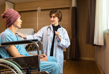 Cancer man patients in wheelchairs receive rehabilitation treatment at clinic. Young female doctor medical therapy treatments.Young patient with a smiling and friendly expression.