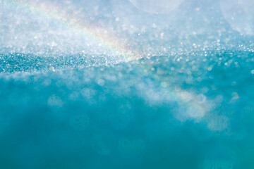 Rainbow arcs over ocean spray