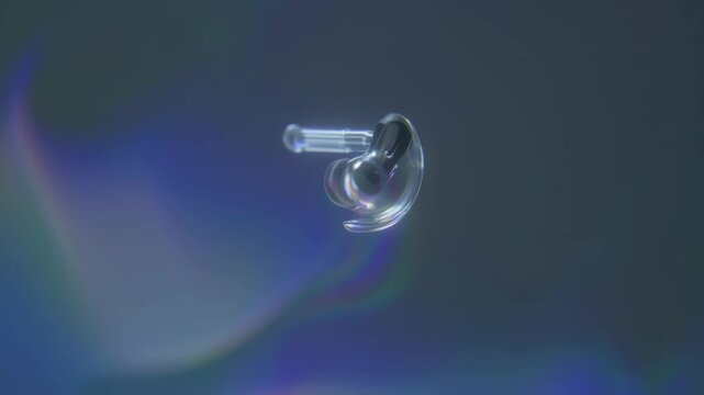 Close-up of transparent custom molded earplug or hearing aid on iridescent holographic background with soft diffused lighting and modern feel for healthcare or technology