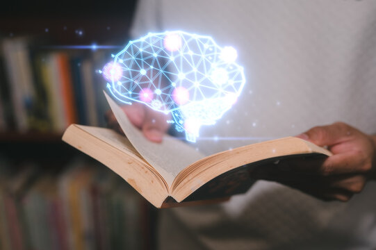 a man holding book and Glowing virtual brain icon in concept of knowledge is power. Self learning education knowledge and business studying concept. Idea of learning online class e-learning at home - Powered by Adobe