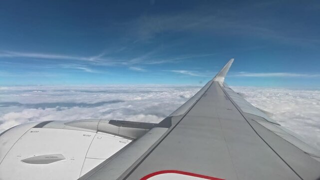 Airplane flying above the clouds from airplane window. Flight take off & Flight landing at International airport, airport terminals, airport passenger gates. airbus a320. flight travel experiences.