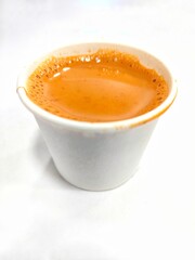Indian hot tea in white paper cup 