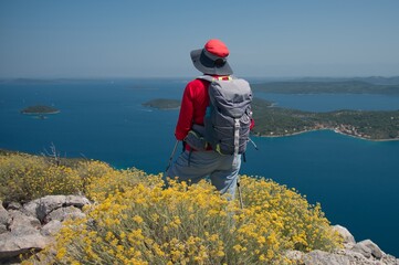 Senior woman standing on the top of the mountain above the Adriatic sea
