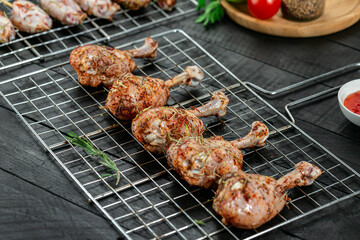 Marinated chicken thigh drumstick ready for grilling.