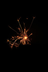 Yellow sparks fly on a black background, layered with grain, noise, and glowing effects to give a gritty, cinematic feel full of motion, contrast, and intense visual energy.