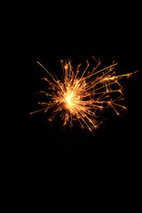 Yellow sparks fly on a black background, layered with grain, noise, and glowing effects to give a gritty, cinematic feel full of motion, contrast, and intense visual energy.