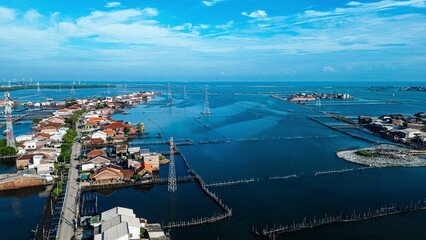 An area in Demak, Central Java, Indonesia, experiences daily tidal flooding, leading to land...