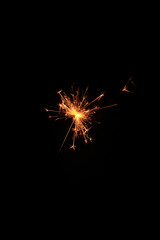 Fototapeta premium Yellow sparks fly on a black background, layered with grain, noise, and glowing effects to give a gritty, cinematic feel full of motion, contrast, and intense visual energy.