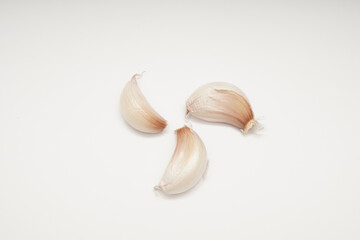 Photographic still life of garlic cloves on white background for culinary use minimalist food photography