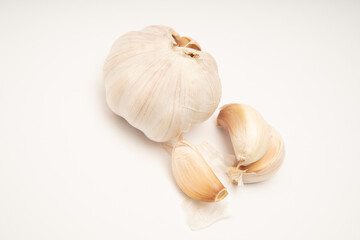 Photographic still life of garlic bulb and cloves for culinary blogs recipe websites or nutritional content food photography style
