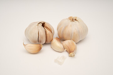 Realistic photograph of garlic bulbs and cloves culinary still life for food blogs recipe websites cooking magazines and health articles