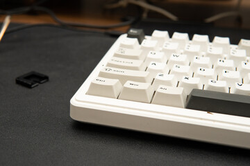 Close-up photograph of white mechanical keyboard on black desk mat for tech blogs product reviews...
