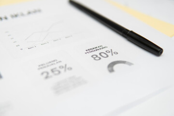 Photographic image of a business report with data graphics and typography, corporate presentation visuals, professional and analytical style