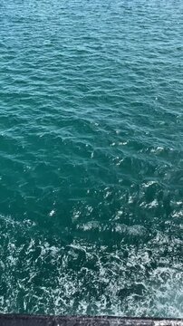 Blue Ocean Wave Trails from Moving Ship &ndash; Horizontal Footage Captured at Sea with Clear Water Splash and Motion