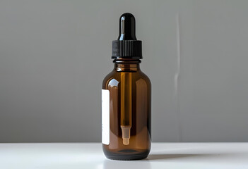 Amber glass dropper bottle with a blank white label on a minimalist grey background, ideal for cosmetic mockups.