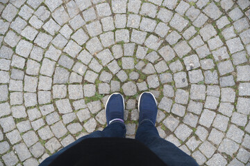 Standing on a cobblestone pathway with patterned stones