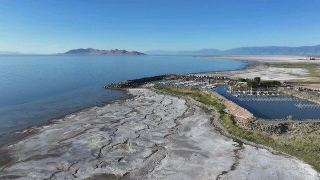 Aerial Utah State Marina Park Great Salt Lake pull 2. Largest saltwater lake in the Western Hemisphere. Solar evaporation ponds produce salt, potassium, magnesium. Recreation and industry.