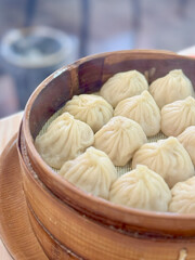 Steamed xiao long bao dumplings in traditional bamboo basket
