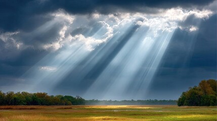 Stress relief in grief recovery and hope focus concept. Stunning rays of sunlight breaking through dark clouds over fields.