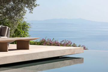 Relaxation spot with pool and coastal view in a sunny outdoor setting