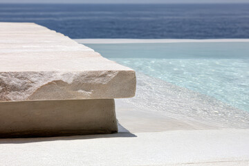 Serene infinity pool edge with stone details overlooking calm ocean waters