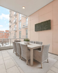 Modern outdoor dining area on a balcony with stylish furniture and city view