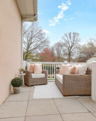 Cozy balcony seating with outdoor furniture and serene spring scenery in a residential area