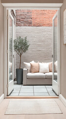 Cozy outdoor seating area visible through open double doors in modern design