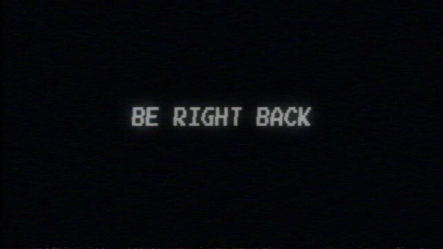 Be Right Back Text Flicker Effect VHS on Black Background. 4K Video