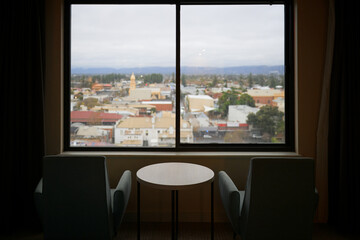 travel rainy day, view from hotel window onto city roof cityscape, grey winter weather