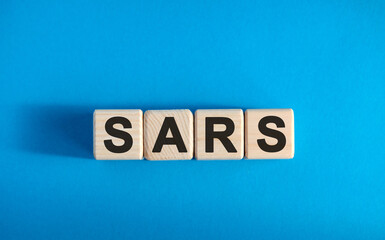 SARS - text on wooden blocks, medical concept, blue background