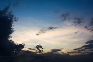 The evening blue-yellow sky and the dark clouds are moving.