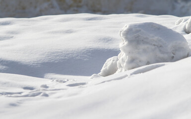 A snow covered hill with a small snow mound in the middle