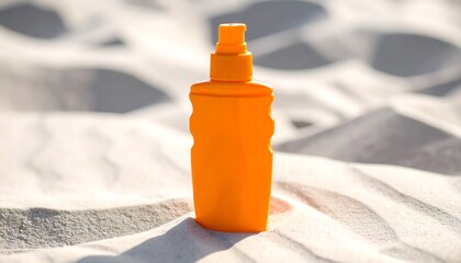 Orange sunscreen bottle on beach sand