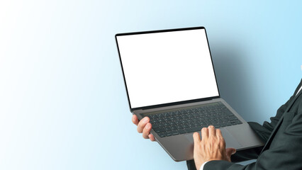 パソコンを持って操作する男性