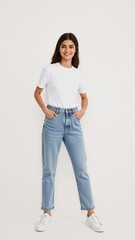 Full length of confident Egyptian girl smiling in a casual outfit in a white tshirt and jeans standing with her arm and leg crossed on plain white background
