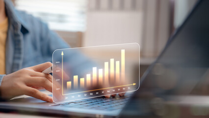 Business analytics and data visualization concept. Hand using stylus with virtual graph showing...