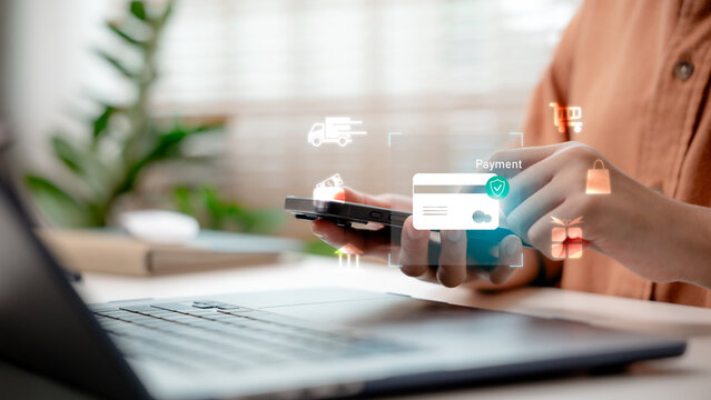 Online payment via smartphone with credit card hologram icons. Digital finance, fintech transactions, secure e-commerce checkout, mobile shopping, and contactless payment.