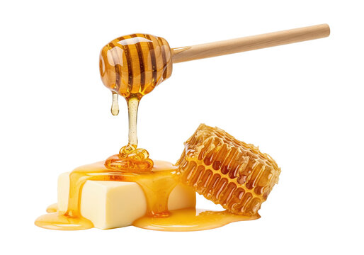 Golden honey poured from a dipper onto butter cubes next to honeycomb, isolated on transparent background