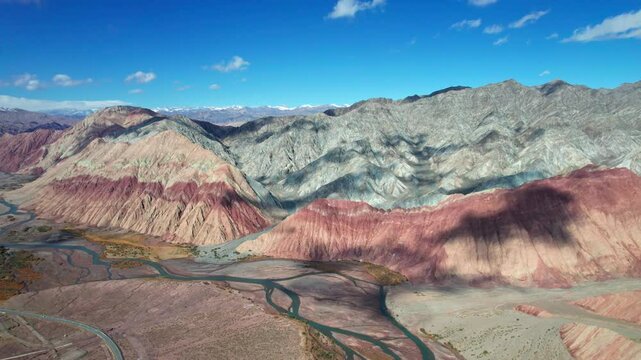 Drone view of Yadan landform near Kashgar in southern Xinjiang, China. High angle view of colorful mountains in sunny autumn day, 4k hyper time lapse landscape footage b roll shot.