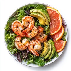 Fresh shrimp salad with mixed greens avocado grapefruit slices and black pepper on white plate healthy nutritious seafood dish