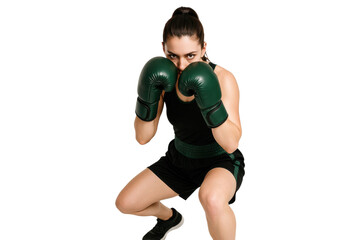 Focused female boxer in guard stance wearing green boxing gloves, isolated on transparent background